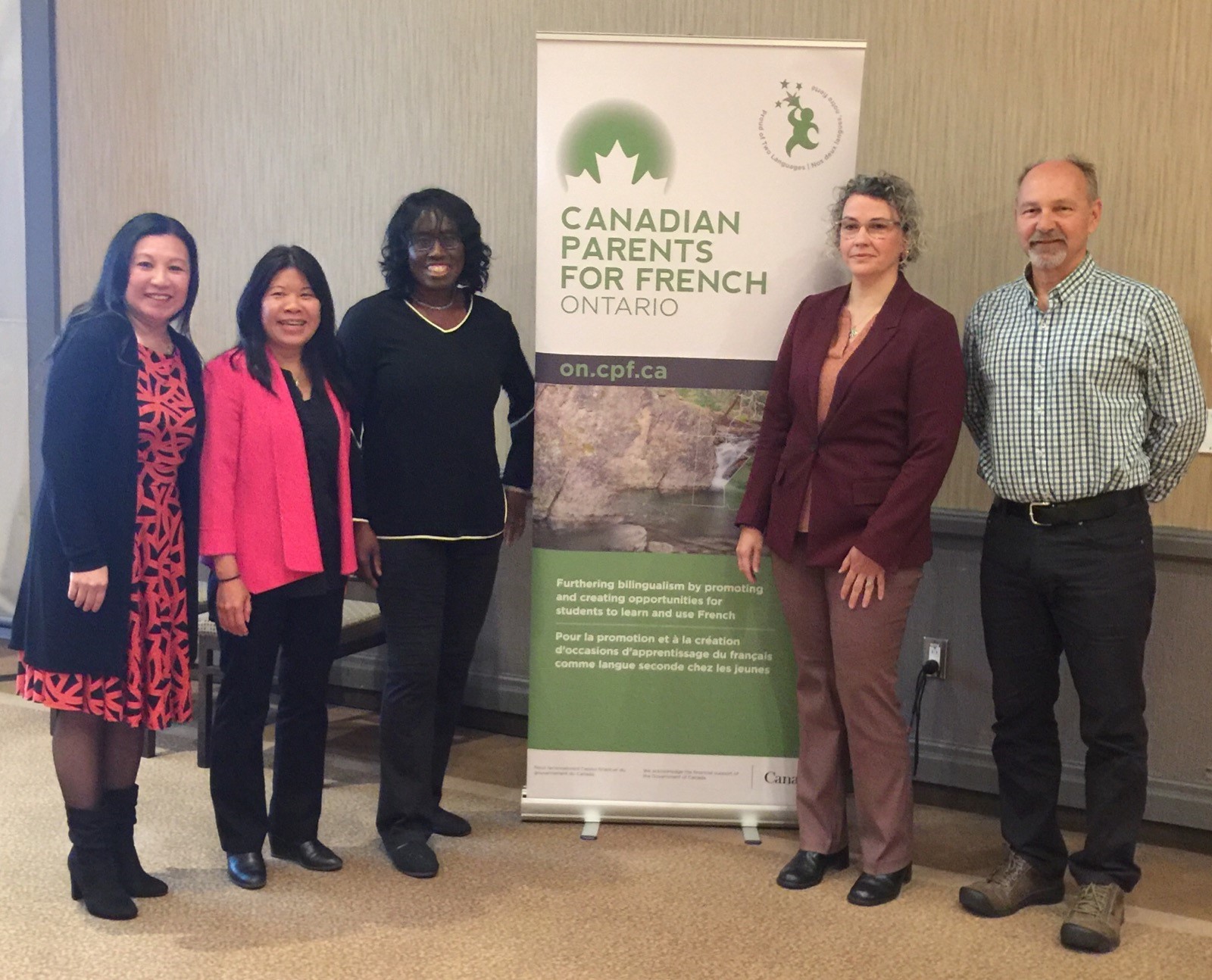 5 new members of the board standing beside a CPF branded sign